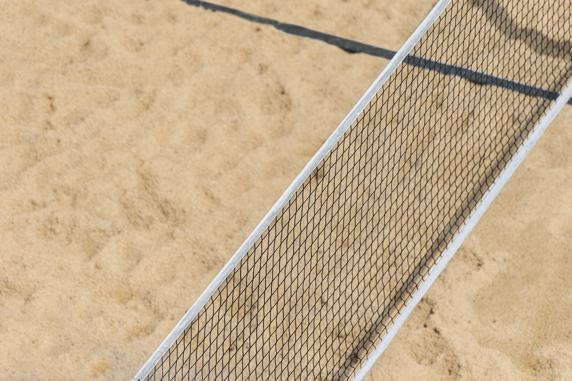 Beach volleyball and beach tennis net on the background of sand. Summer sport concept